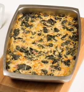 Baked spinach and cheese casserole in metal baking dish