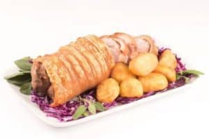 Roast pork belly with crispy skin and golden potatoes