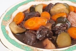 Hearty beef stew with carrots, potatoes, and gravy plate