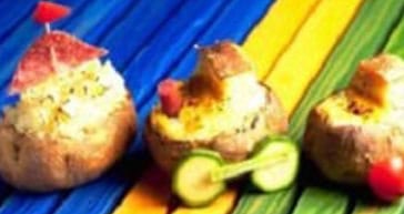 Stuffed baked potatoes on colorful wooden background with vegetables