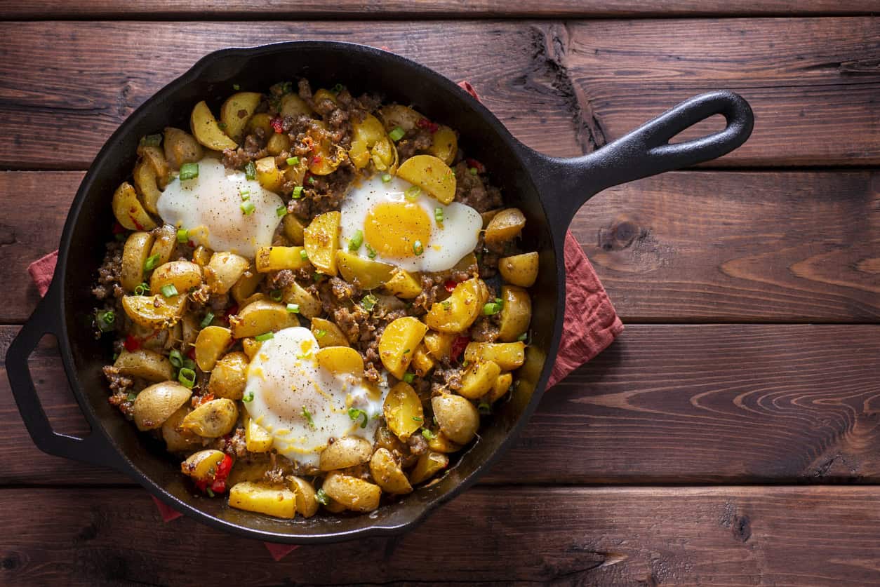 Skillet hash with potatoes, ground meat, and fried eggs