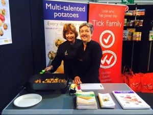 Two women promoting multi-talented potatoes at event booth