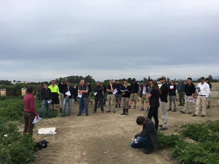 Group of people attending outdoor agricultural field training session