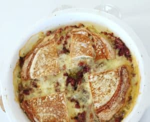 Baked cheese and bread casserole with bacon bits