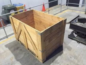 Large empty wooden crate on concrete floor