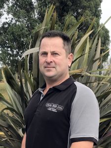 Man in black and gray Moran Smith-Dawe polo shirt outdoors