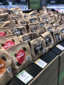 Bags of Vivaldi and colorful potatoes displayed in grocery store