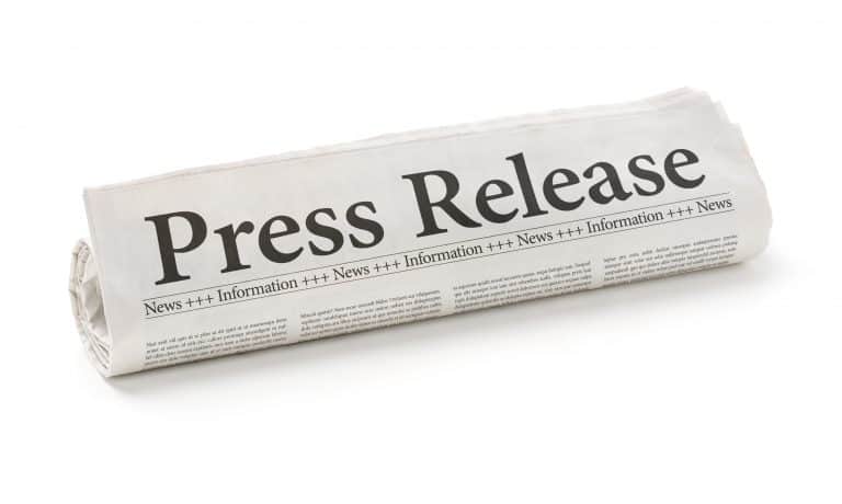 Rolled newspaper with the headline Press Release