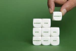 Hand building sustainability strategy with cubes. Final touch.