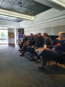 Panel discussion at agricultural conference with Potatoes New Zealand banners.