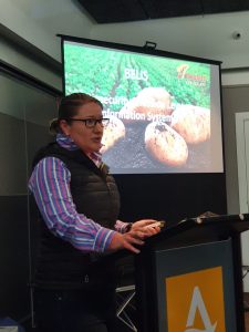 Woman giving presentation on potato industry in conference room