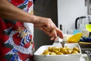Close-up of a Man preparing the new potatoes for Christmas Dinner.