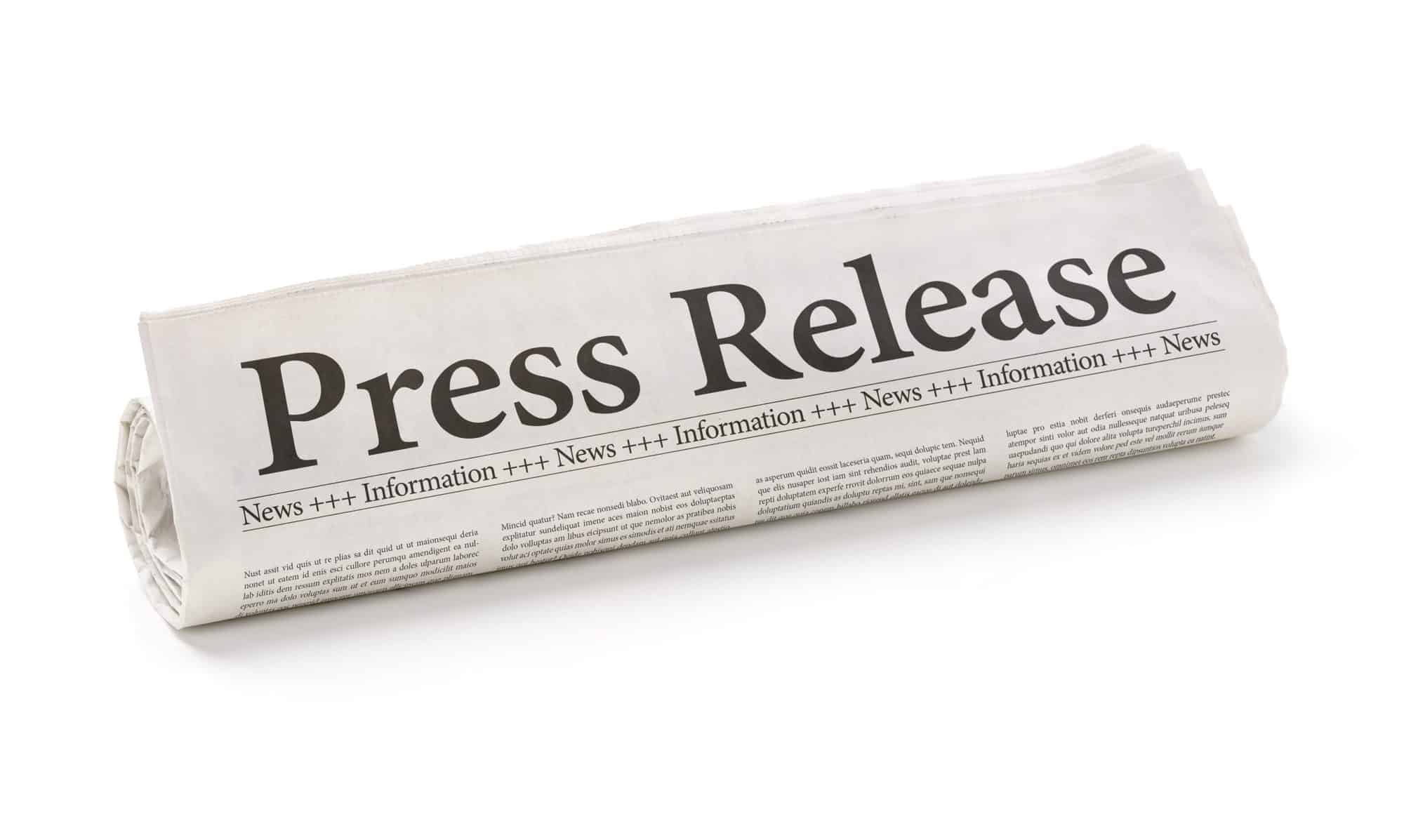 Rolled newspaper with the headline Press Release