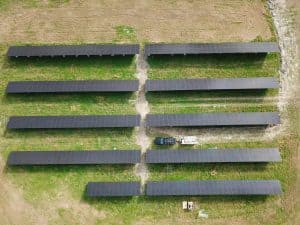 Aerial view of solar panels installation with truck and trailer