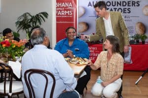 Group dining event with people talking and interviewing
