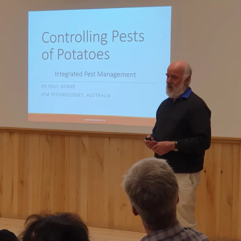 Presenter giving lecture on controlling potato pests with integrated pest management