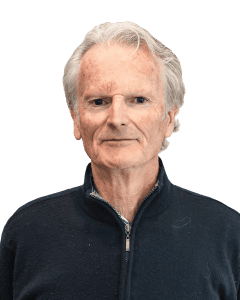 Senior man with white hair wearing navy blue zip-up sweater