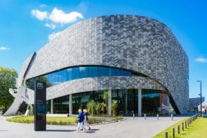 Modern curved building exterior with chevron patterned facade
