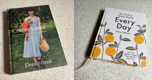 Two vegetarian cookbooks on a speckled countertop.