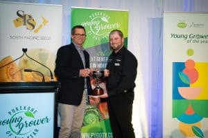 Two men holding trophy at Pukekohe Young Grower award ceremony