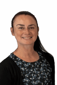 Smiling woman with dark hair wearing floral dress and black sweater