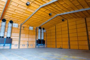 Empty industrial warehouse interior with yellow insulated walls