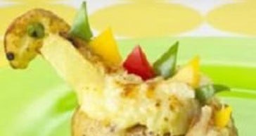 Baked potato topped with melted cheese and colorful peppers