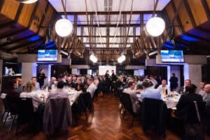 Corporate dinner event with attendees seated at round tables