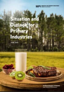 Milk, kiwi, cherries, and steak on wooden table, forest background