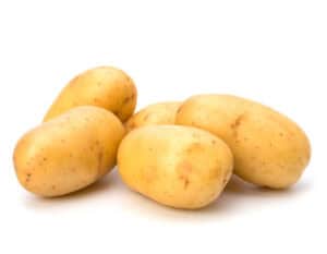 Group of fresh raw yellow potatoes on white background