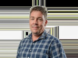 Smiling man with short hair wearing blue plaid shirt isolated background