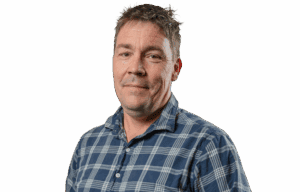 Middle-aged man with short hair wearing blue plaid shirt