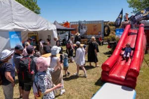 Outdoor family event with children playing on inflatable slide