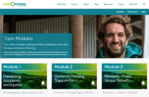 Smiling man with farm safety and wellbeing online modules displayed.